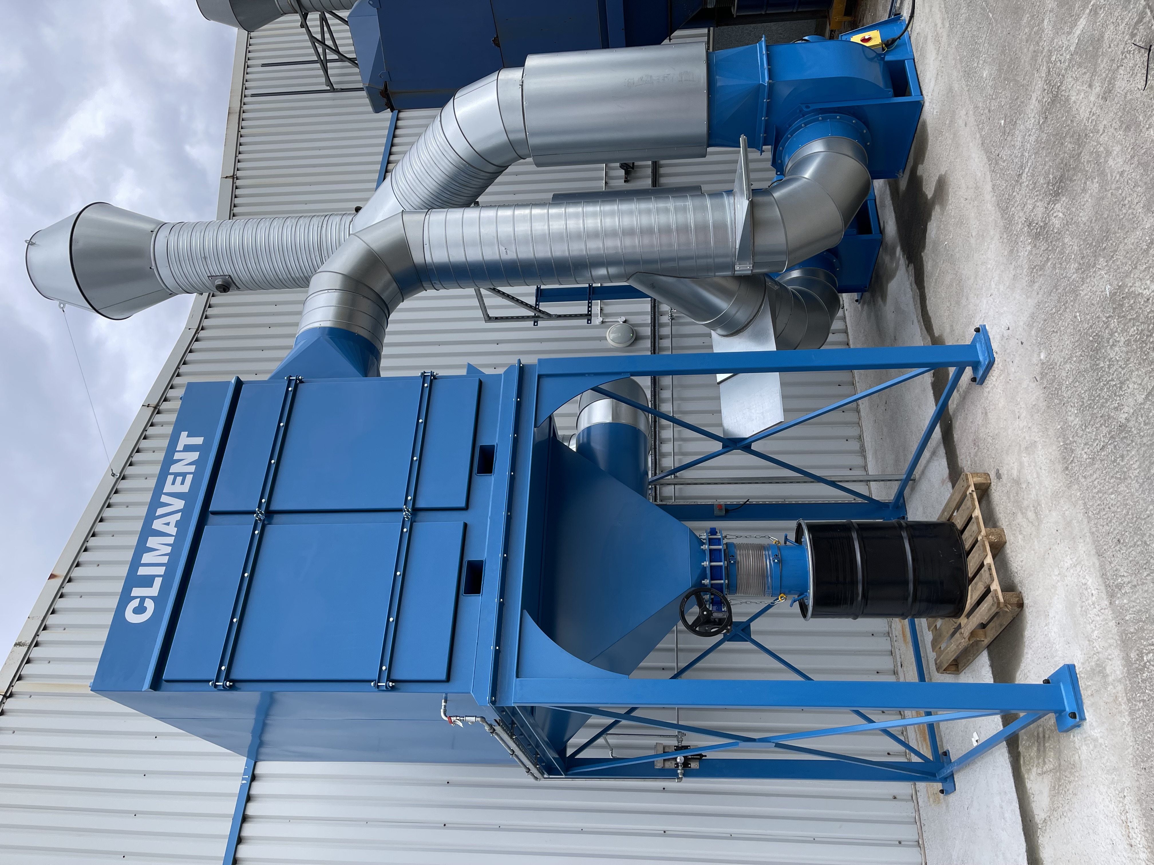 Reverse jet filtration unit sited externally with a centrifugal fan and interconnecting ductwork used to connect between the filter unit and the extraction requirements inside the building.