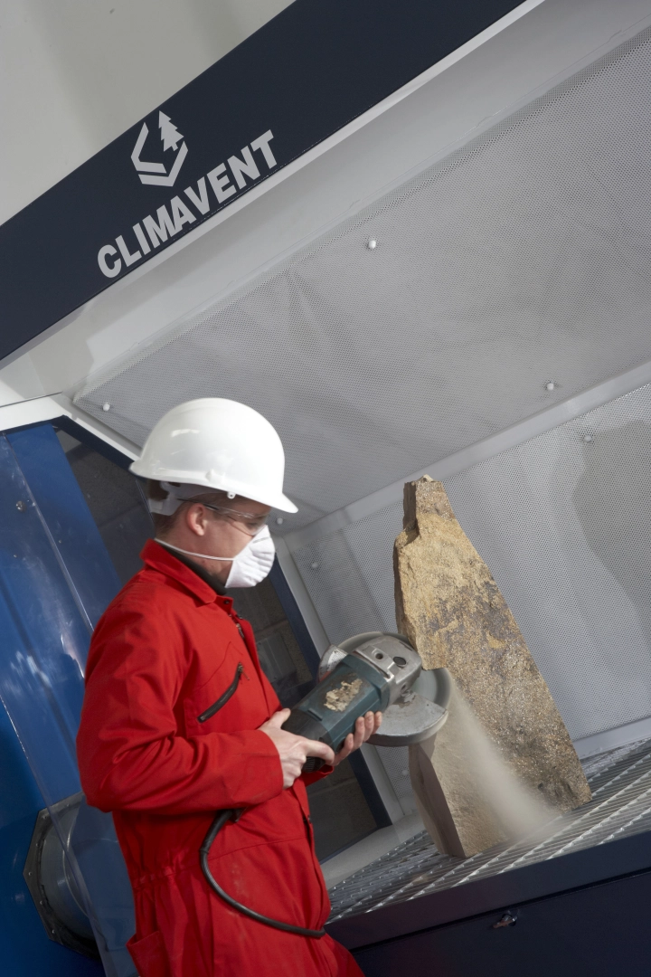 Stone cutting being undertaken on heavy duty down draught bench