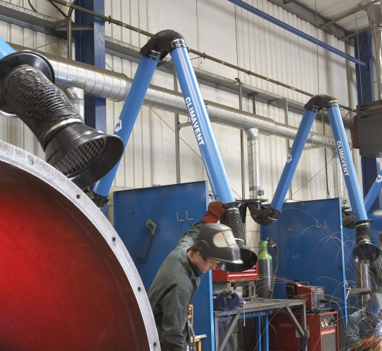 Welding fume extraction arms being used in a factory environment, connected onto a local fume extraction system